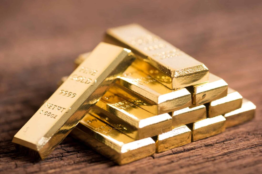 stack of gold bar on wood background