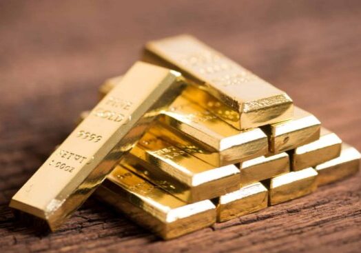 stack of gold bar on wood background